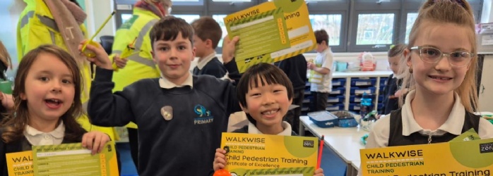 Children from Marine Academy holding their Walkwise certificates 